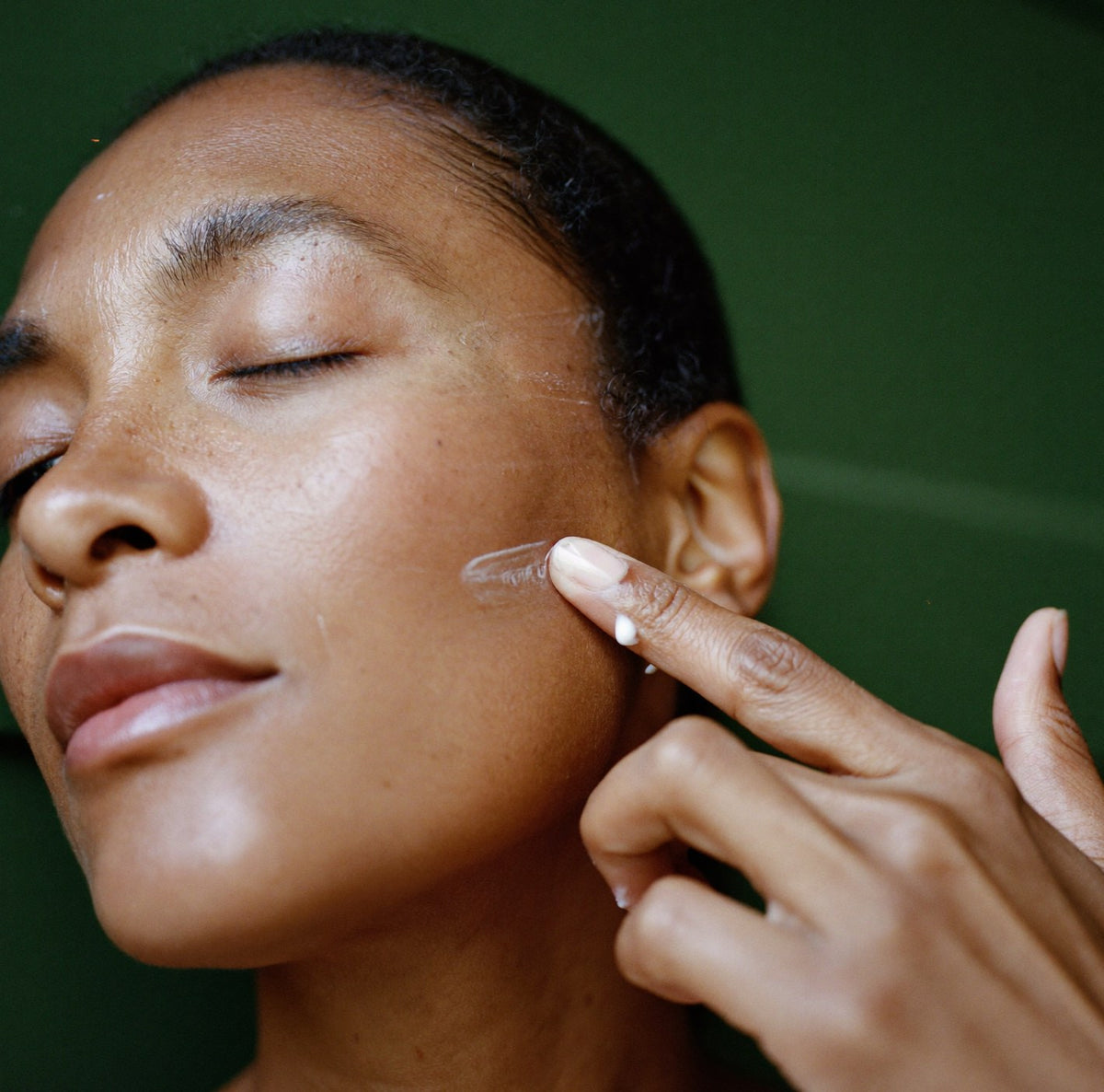 Pressing the cream into the cheek