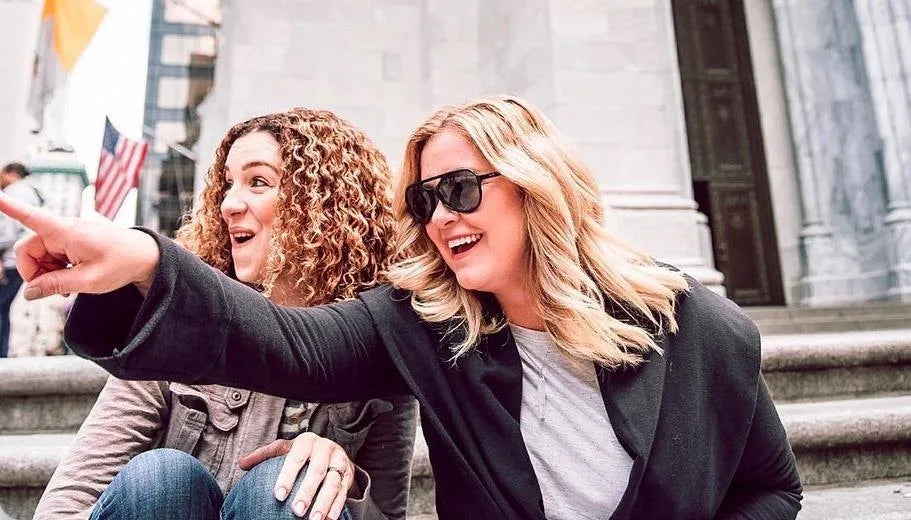 Amy Lacey and Jimi Sturgeon-Smith laughing on city steps